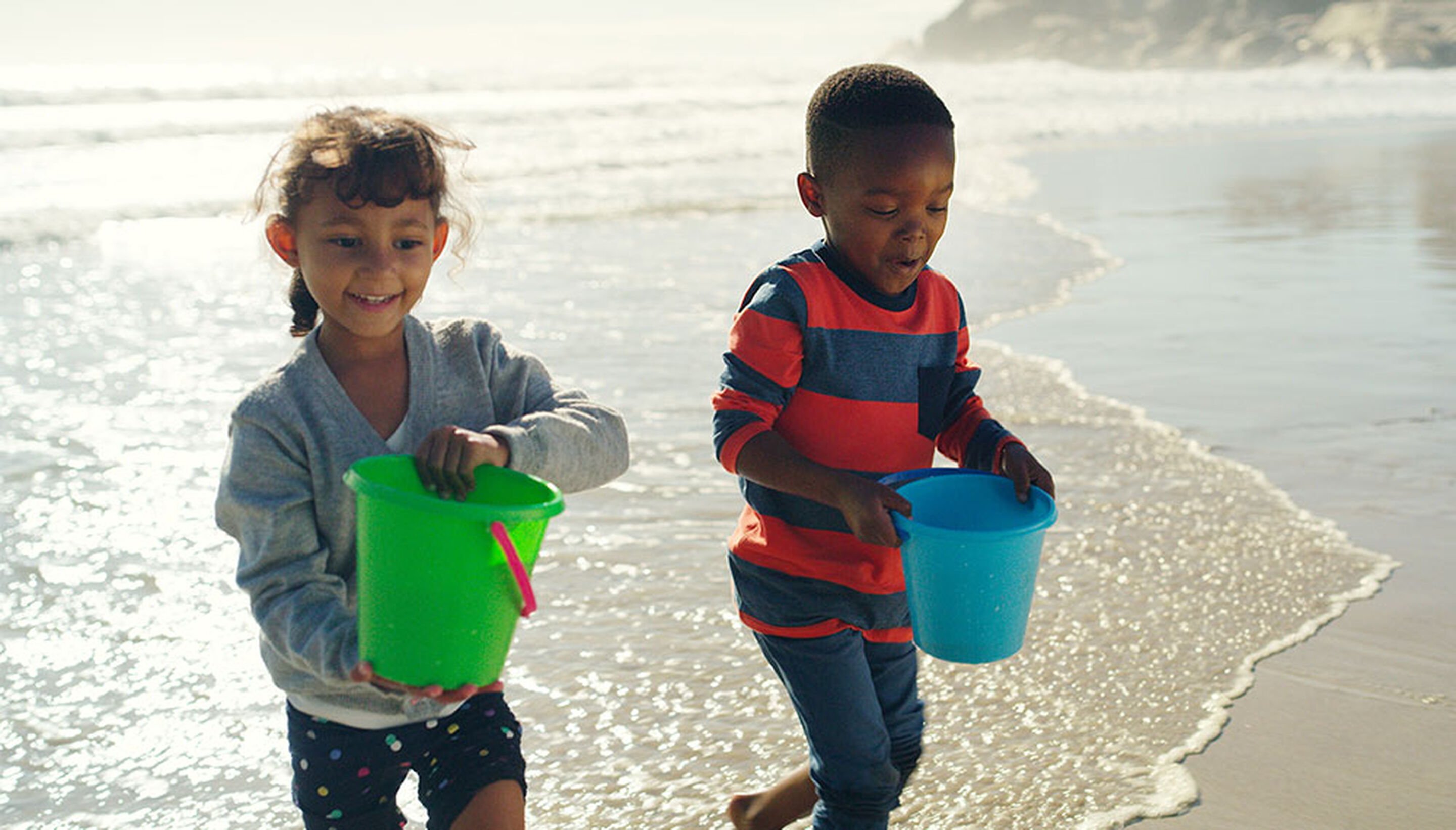 Beach games for kids &ndash; playing with a ball near the water